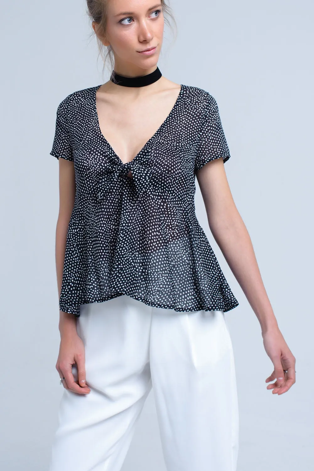 Black polka dot top with ruffle hem